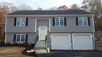 Two-story gray house with black shutters, white trim, and a double garage.