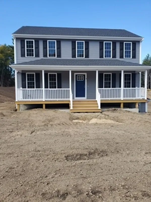 Two-story gray house with white trim, blue door, front porch, and bare yard.