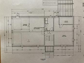 Floor plan drawing showing labeled rooms, doors, stairs, and measurements in feet and inches.