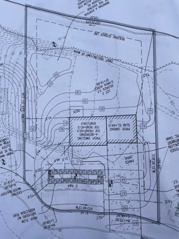 Black and white site plan drawing showing property lines, topography, and building layout.