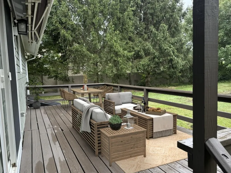 Wood deck with outdoor seating, dining table, and trees in the background.