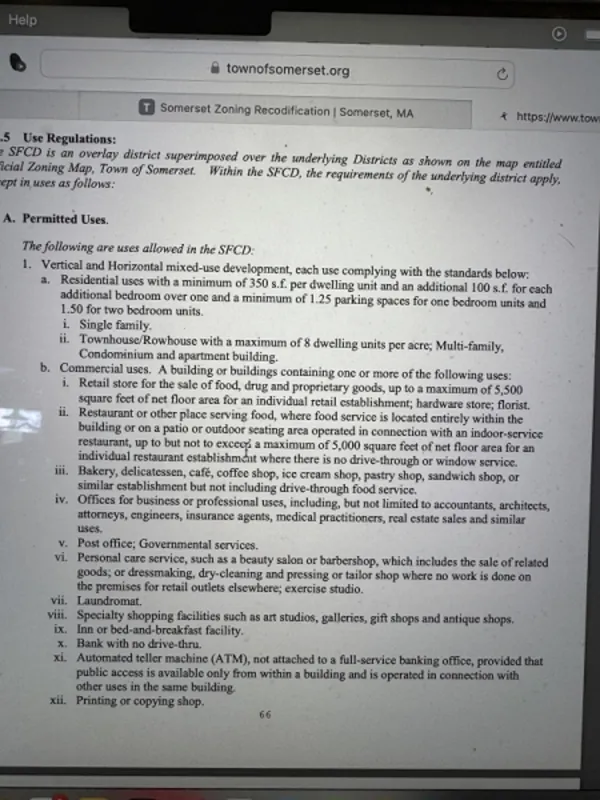 A tablet screen displays a zoning regulations document with text about permitted uses in SFCD.
